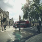 group of people walking on London road beside double deaker bus