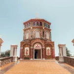 a small church with a cross on top of it